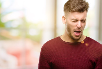 Handsome young man crying depressed full of sadness expressing sad emotion