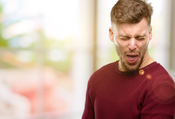 Handsome young man crying depressed full of sadness expressing sad emotion