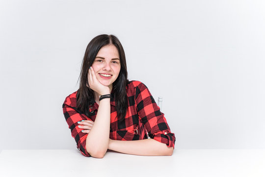 beautiful girl sitting at a table in different poses