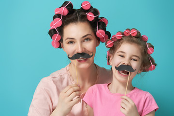 Mother and her daughter with a paper accessories