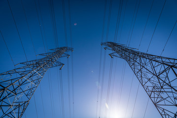 High voltage electrical pylons ruling the sky.