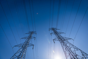 High voltage electrical pylons ruling the sky.