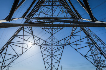 High voltage electrical pylons ruling the sky.