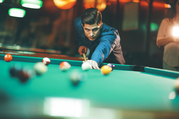 Young man playing pool