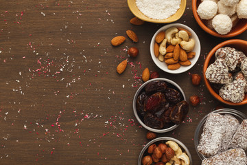Wooden desktop with assortment of healthy sweets and nuts