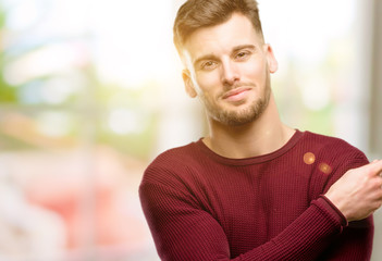 Handsome young man pointing away side with finger