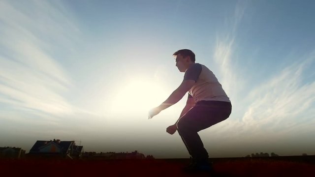 Parkour tricker jumper performs amazing flips, silhouette