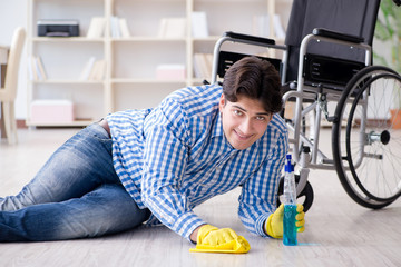 Disabled man on wheelchair cleaning home