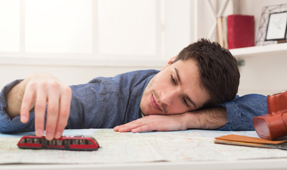 Man dreaming about travel, looking at map