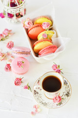 Dessert: A Delicate Fresh French Macaroons In Pastel Colors Gift Box With Flowers Roses On A Light Textile Background