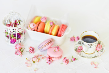 Dessert: A Delicate Fresh Colorful French Macaroons In Pastel Colors With Flowers Roses On A Light Textile Background, Top View