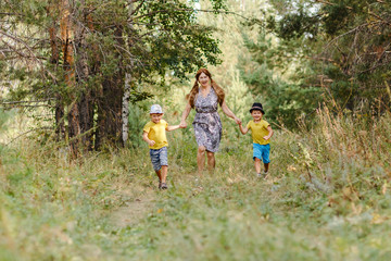 Obraz premium grandmother with two grandsons running in the Park