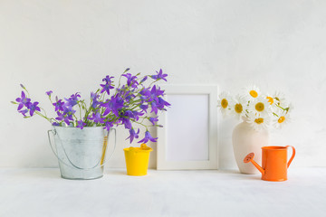Mockup with a white frame and summer flowers