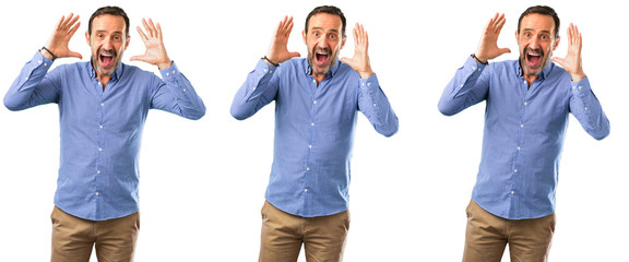 Middle age handsome man happy and surprised cheering expressing wow gesture over white background