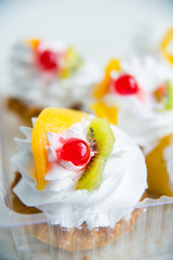 a set of pastries: cream puffs and fresh fruit