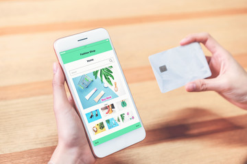 Women hold the smartphone and credit card shopping online store. The concept of providing marketing services on the internet for easy access to information.