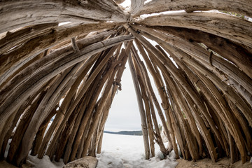 Fisheye view inside of a teepee that is located on a winter lake