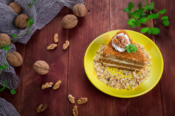 Honey cake on a plate. Wooden rustic background