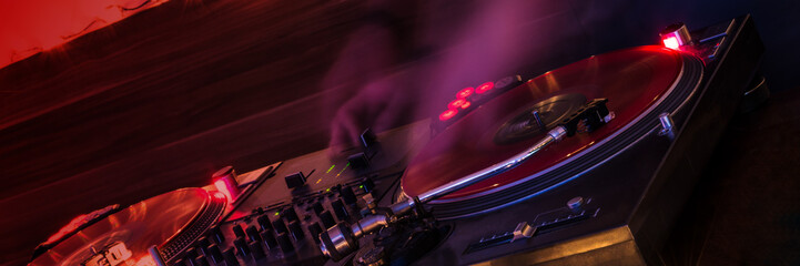 panorama of turntable with vinyl disk on fire, dj playing music
