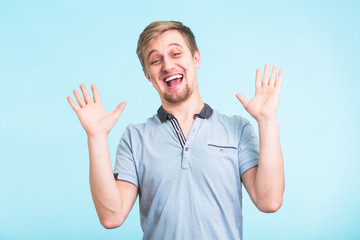 Fototapeta premium Excited man exclaimed in happiness, gestures actively, expressed great surprisement, over blue background