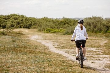Obraz premium Middle-aged woman riding bicycle