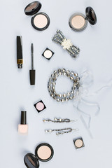 Female fashion accessories, makeup products, jewelry flat lay on pastel background. Beauty and fashion concept