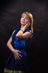 Fototapeta premium Portrait of a girl in a blue dress