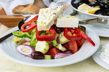 Traditional greek salad with fresh vegetables, feta cheese and olives.