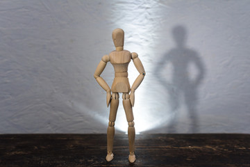 wooden toy in the image of a man on a white background