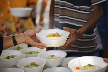 Feeding the poor to hands of a beggar. Poverty concept
