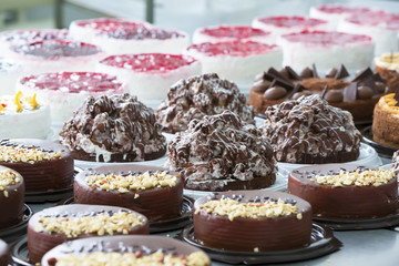 Industrial line of cakes. Many beautiful cakes on the table