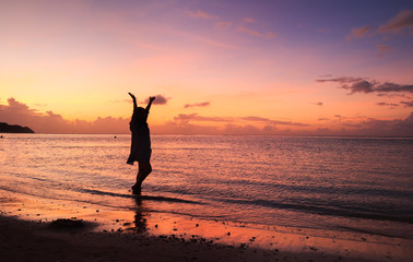 Fototapeta na wymiar Woman's silhouette in the beautiful sunset