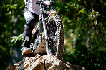 Trials motorcycle while competition in nature park, close up shot