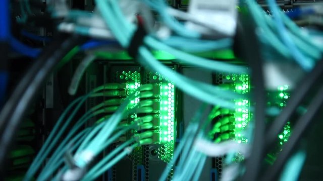 Close up fiber optics cable connecting on server