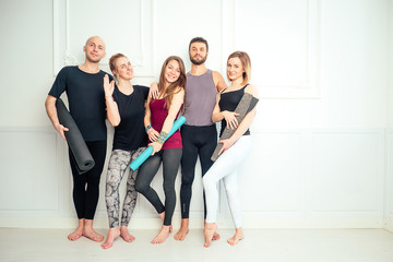 Fototapeta na wymiar happy group of people from men and women practicing yoga in fun in the studio. groups of meditation and support in the yoga class. yoga, mate, man, woman, many people
