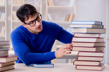 Male student preparing for exams in college library