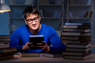 Student preparing for exams late at night in library