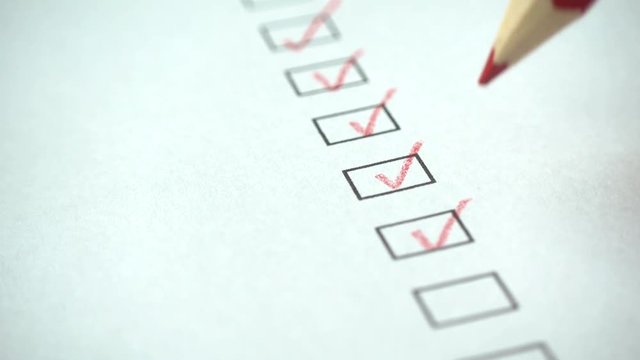 A person checking off a to do list with red pencil. Check all the boxes of a checklist, close-up, 4k