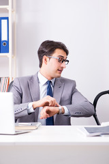 Businessman looking after newborn baby in office