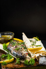 Fish grilled and served in corn husk with herbs