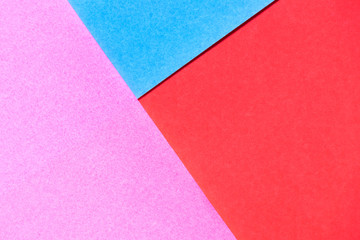 Pink, red and blue color paper display as abstract blank background
