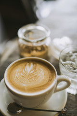 latte art and brown sugar on table