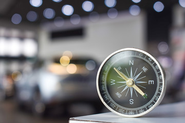 holding compass on blurry background