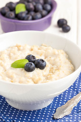 Oatmeal porridge with blueberries, tasty and healthy breakfast