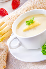 asparagus cream soup with capers and fresh baguette