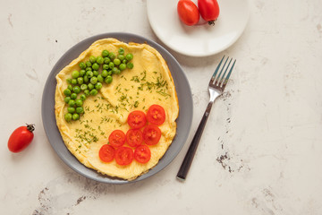 Omelette with green peas and cherry tomatoes. Protein breakfast
