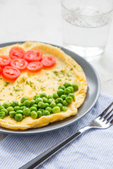 Omelette with green peas and cherry tomatoes. Protein breakfast