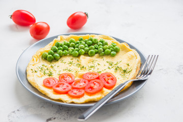 Omelette with green peas and cherry tomatoes. Protein breakfast