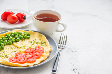Omelette with green peas and cherry tomatoes. Protein breakfast