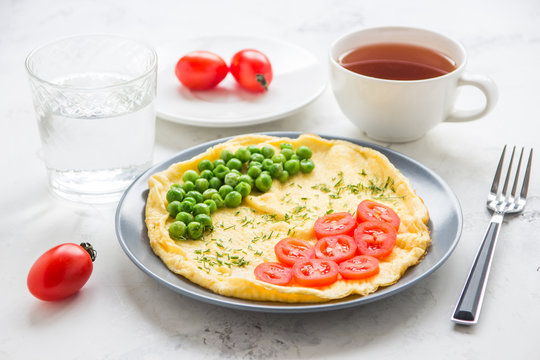 Omelette with green peas and cherry tomatoes. Protein breakfast